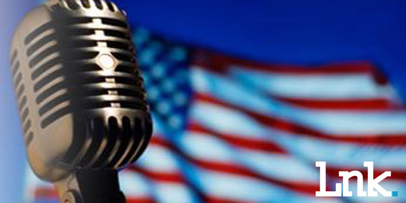 microphone with U.S banner in background